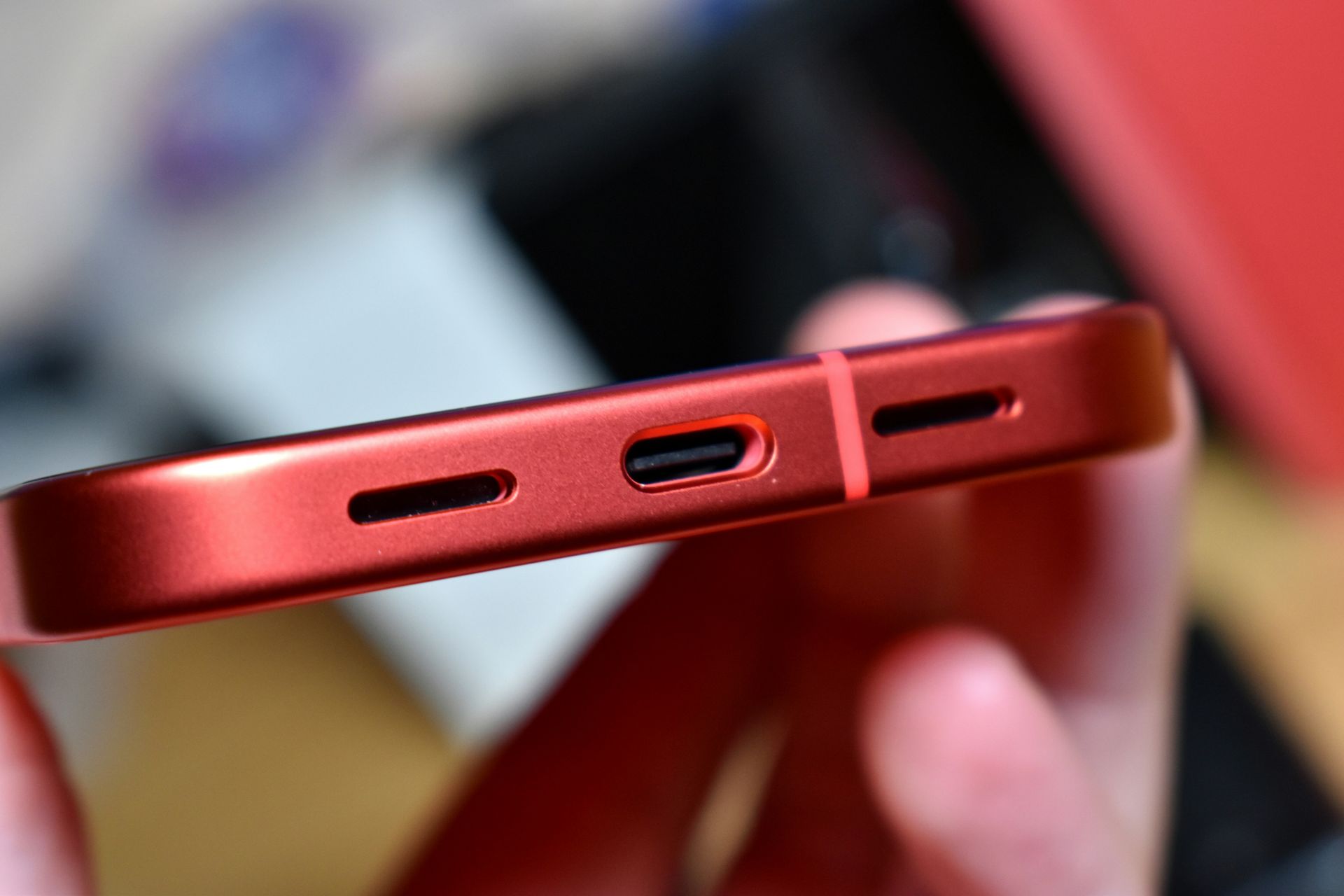 Close-up of a red smartphone charging port